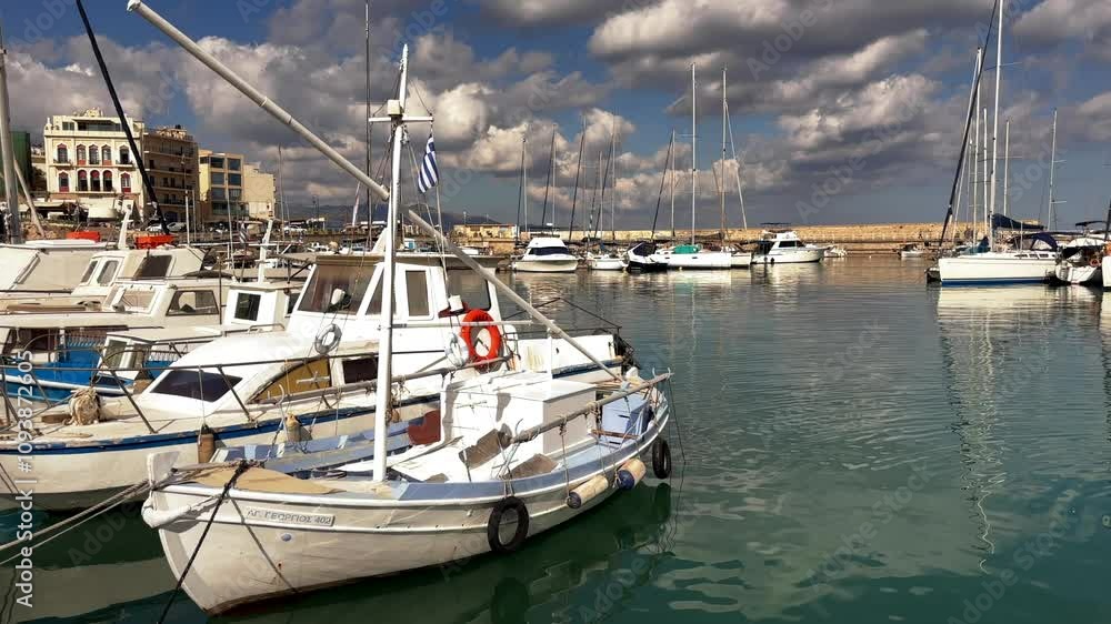 Boats docked at the marina in Heraklion, Crete, Greece under a cloudy sky Boats docked at the marina in Heraklion, Crete, Greece under a cloudy sky