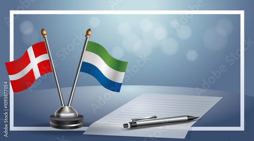 Denmark and Sierra Leone National flags on small table with bokeh background, cooperative relationship