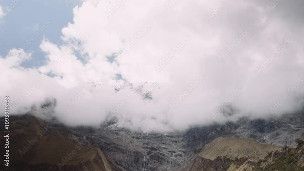 Clouds Over Mountains At The Blue Lagoon Of Humantay Lake In Cusco, Peru. Tilt-up Shot Clouds Over Mountains At The Blue Lagoon Of Humantay Lake In Cusco, Peru. Tilt-up Shot
