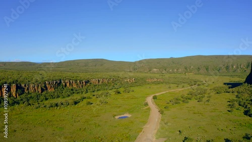 Hells Gate National Park is famous for its stunning scenery, vibrant greenery, and winding pathways through rocky cliffs, all under a beautiful blue sky, enhancing its natural allure. Kenya. Africa