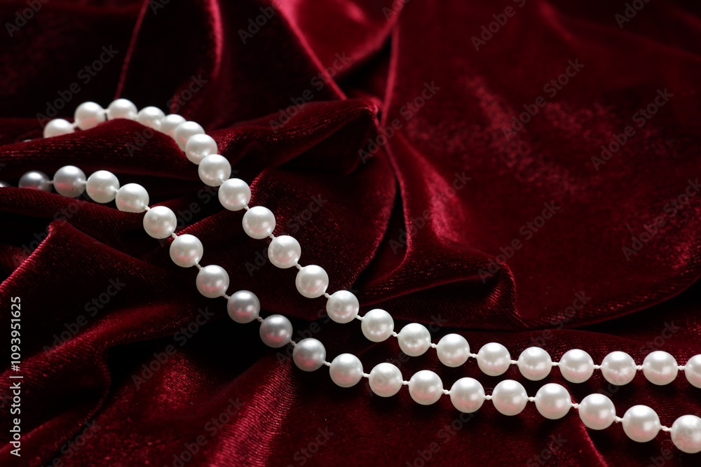 Beautiful pearl necklace on red cloth, closeup Beautiful pearl necklace on red cloth, closeup