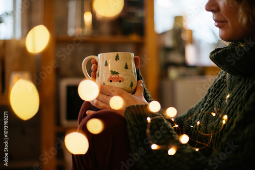 Принти на полотні Woman holding a cozy Christmas mug, creating holiday warmth