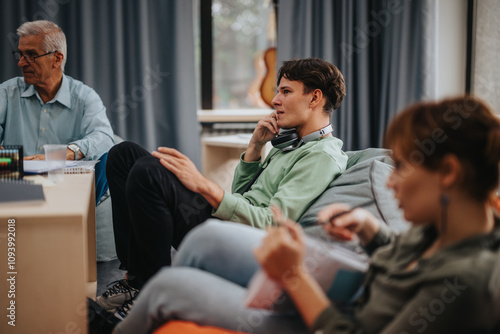 A professor engages with attentive students in a relaxed classroom environment, fostered for collaborative learning and discussion. The image captures an academic setting focused on education and