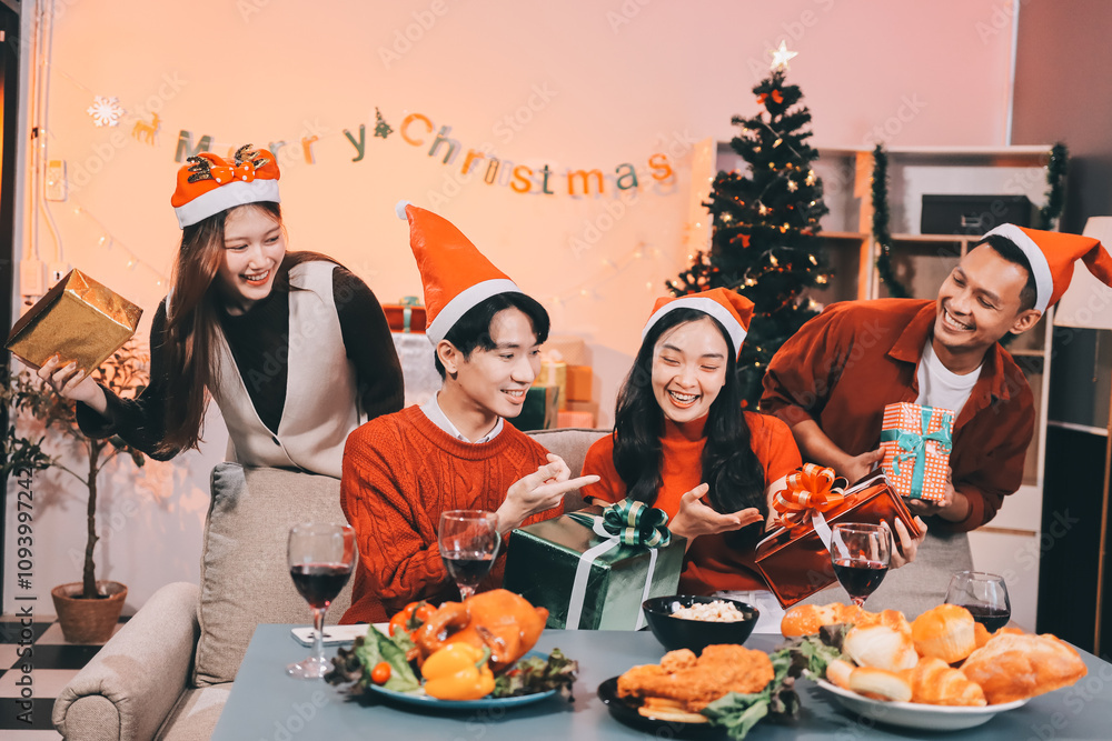Group of young Asian man and women as friends having fun at a New Year's celebration, holding gift boxes standing by Christmas tree decoration, midnight countdown Party at home with holiday season. Group of young Asian man and women as friends having fun at a New Year's celebration, holding gift boxes standing by Christmas tree decoration, midnight countdown Party at home with holiday season.