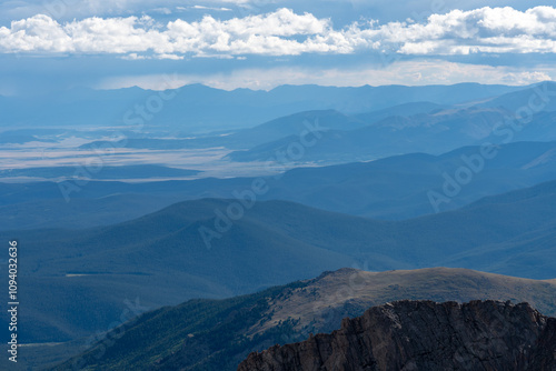 A breathtaking view of layered mountain ranges under a vibrant sky showcasing the beauty of natural landscapes in Colorado