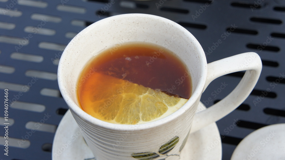 Warm Cup of Tea with Lemon Slice on Outdoor Table Warm Cup of Tea with Lemon Slice on Outdoor Table