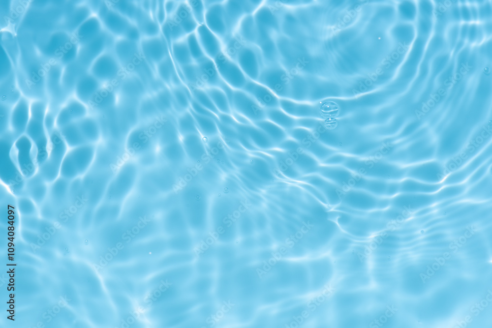 Blue water with ripples on the surface. Defocus blurred transparent blue colored clear calm water surface texture with splashes and bubbles. Water waves with shining pattern texture background. Blue water with ripples on the surface. Defocus blurred transparent blue colored clear calm water surface texture with splashes and bubbles. Water waves with shining pattern texture background.