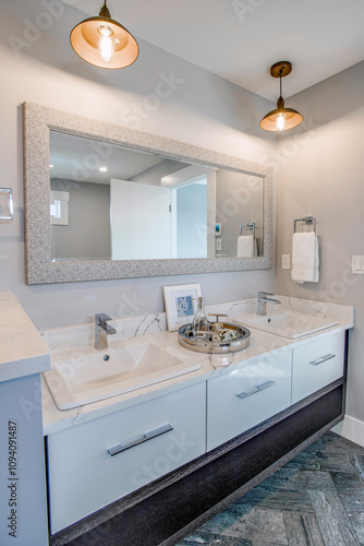 A bathroom with a large mirror and two sinks