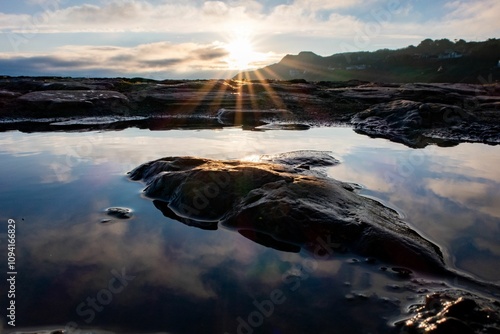 Canvas Print Seascape with sky reflection in rockpools and sunrays in Howth, Dublin