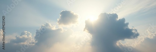 The sun shines through the misty veil of clouA group of clouds drift lazily across the sky their shapes morphing into animals and objects, cloud formations, weather phenomenon, wispy clouds photo