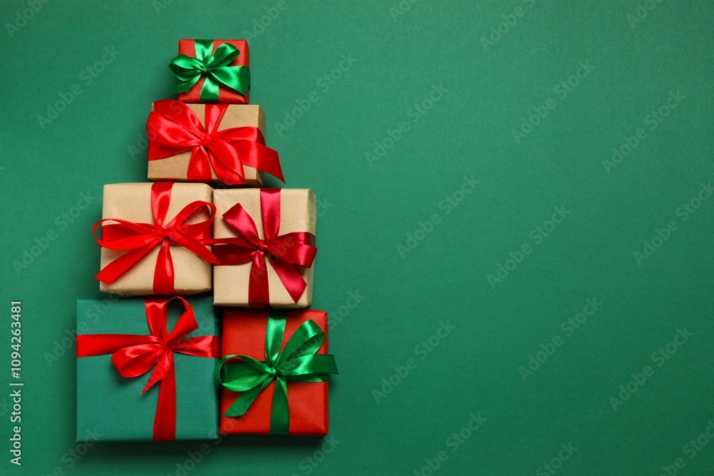 Gift boxes in the form of a Christmas tree on a colored background, top view Gift boxes in the form of a Christmas tree on a colored background, top view