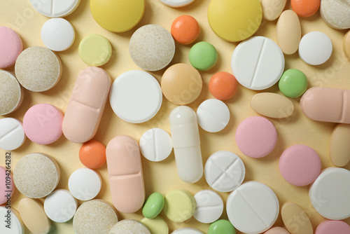 Medicine pills and capsules on a color background