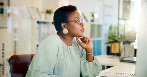 Black woman, office and computer with working and blog post for digital journalist at creative agency. Thinking, employee and desk with tech, writer and company website update with research of staff photo