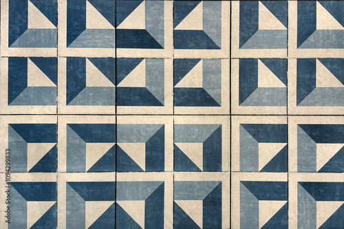 Abstract blue triangular cube geometric pattern painted on floor tiles. Blue modern mid century geometric pattern seamless background texture.