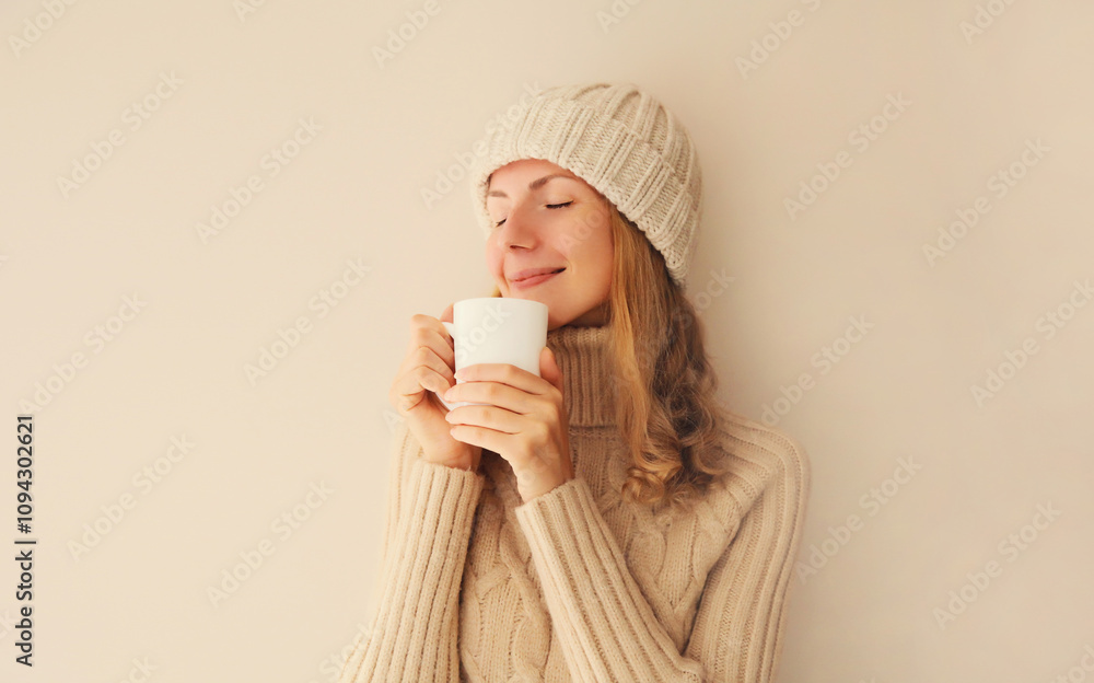 Winter portrait of happy satisfied young woman enjoying cup of hot tasty coffee drink in the morning Winter portrait of happy satisfied young woman enjoying cup of hot tasty coffee drink in the morning