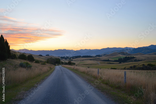 Endless Road Through Rolling Hills at Sunrise