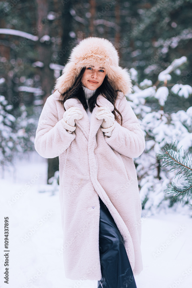 Young woman in snowy forest in winter. Portrait of happy woman playing with snow on sunny winter day. Walk in winter forest. Fun, relaxation concept. Young woman in snowy forest in winter. Portrait of happy woman playing with snow on sunny winter day. Walk in winter forest. Fun, relaxation concept.