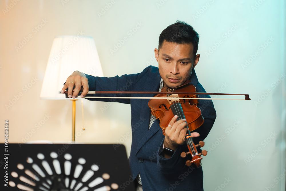 Asian Man Practicing Violin with Focus and Passion. Asian Man Practicing Violin with Focus and Passion.