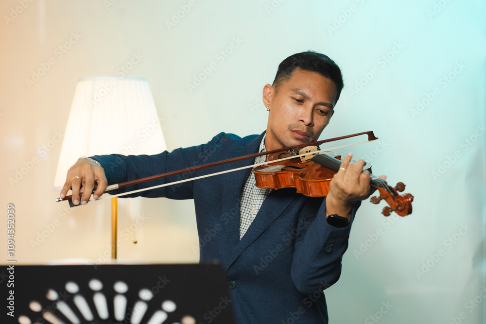 Asian Man Practicing Violin with Focus and Passion. Asian Man Practicing Violin with Focus and Passion.