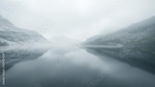 Blurred reflection of a serene lake in the heart of a misty mountain range, mirrored water, mountain lake