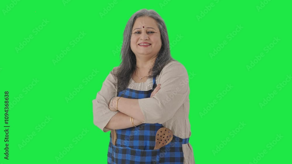 Portrait of Happy Indian aged housewife standing crossed hands Green screen Portrait of Happy Indian aged housewife standing crossed hands Green screen