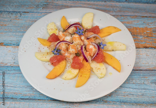 RECIPE CEVICHE OF SHRIMPS AND SCALLOPS WITH CITRUS FRUIT, LEMON, LIME, SQUEEZED ORANGE, GRAPEFRUIT AND FRUIT, PERSIMMON, APPLE, SEASONED WITH ESPELETTE PEPPER. High quality photo photo