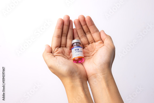 two hands showing a liquid vitamin b12 in the clinic room. health and medical concepts.