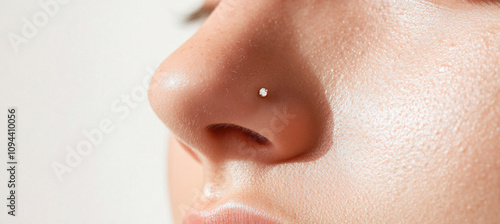 Woman showing nose piercing with small diamond stud