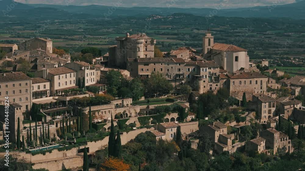 Aerial circling right of Gordes, France, surrounded by lush greenery and hilltop views Aerial circling right of Gordes, France, surrounded by lush greenery and hilltop views