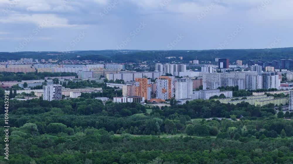 Gdansk Zaspa district in Poland, featuring residential buildings and green areas under a cloudy sky, showcasing urban planning and nature integration drone flying forward Gdansk Zaspa district in Poland, featuring residential buildings and green areas under a cloudy sky, showcasing urban planning and nature integration drone flying forward