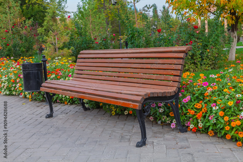 park bench in the park among flowers in autumn park bench in the park among flowers in autumn