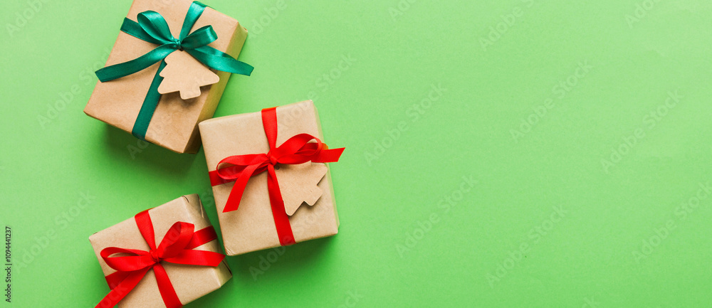 wrapped christmas or other holiday handmade present in paper with colored ribbon. Present box, decoration of gift on colourfull table, top view with copy space wrapped christmas or other holiday handmade present in paper with colored ribbon. Present box, decoration of gift on colourfull table, top view with copy space