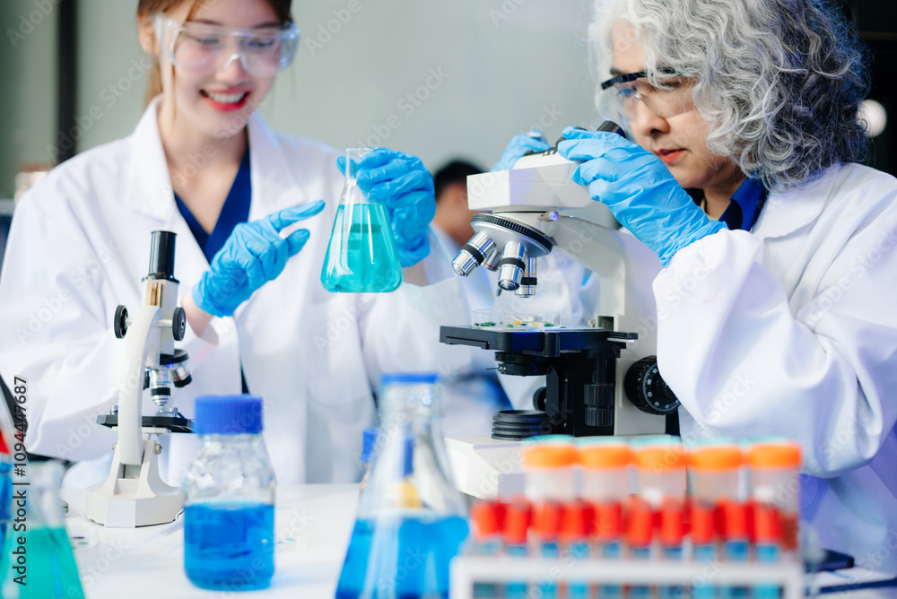 Scientists in lab coats collaborating with test tubes, flasks, and microscopes in a modern lab.