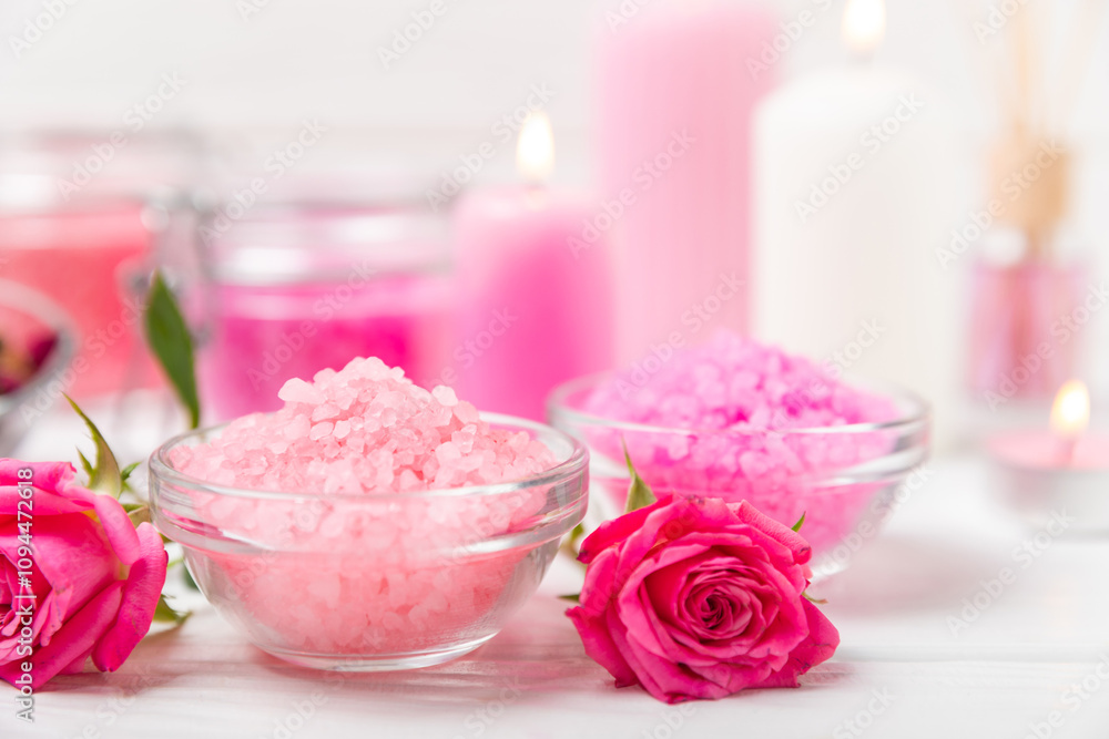 Sea salt for bath with aroma and rose flowers on textured wooden background. Pink sea salt. Spa treatments. Natural salt with herbs and essential oils. skincare concept. Meso for text. Copy space Sea salt for bath with aroma and rose flowers on textured wooden background. Pink sea salt. Spa treatments. Natural salt with herbs and essential oils. skincare concept. Meso for text. Copy space