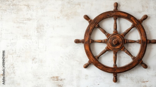 Vintage Wooden Ship Wheel on Textured White Wall Background photo