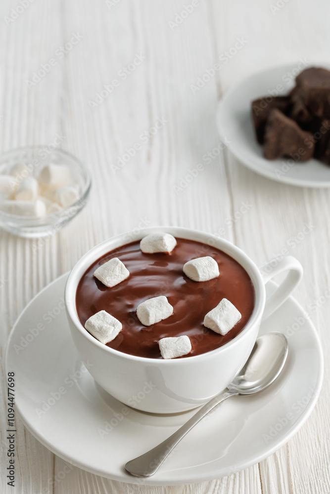 hot melted chocolate with marshmallows in cup on white wooden table hot melted chocolate with marshmallows in cup on white wooden table