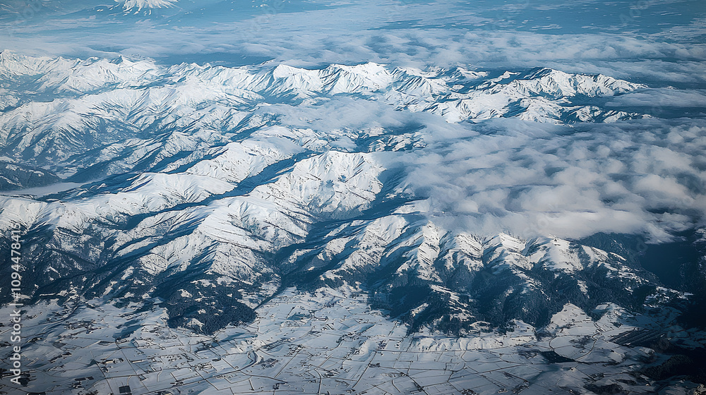 Fototapeta premium A view of a snow mountain range from an airplane