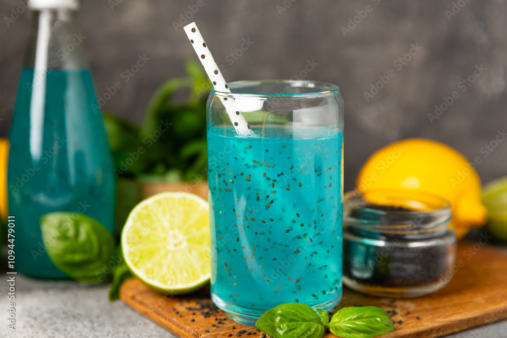Fototapeta premium Diet detox cocktail with basil and chia seeds in a glass jar and a glass on a textured background. Drink with seeds. Health food. Detox cocktail. Antioxidant. Water with basil. Space for text. 