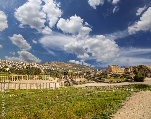 Roman ruins (against the background of a beautiful sky with clouds) in the Jordanian city of Jerash (Gerasa of Antiquity), capital and largest city of Jerash Governorate, Jordan #1094494069