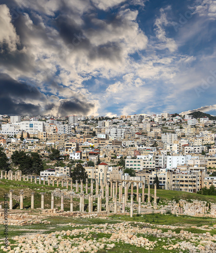 Roman ruins (against the background of a beautiful sky with clouds) in the Jordanian city of Jerash (Gerasa of Antiquity), capital and largest city of Jerash Governorate, Jordan #1094497626