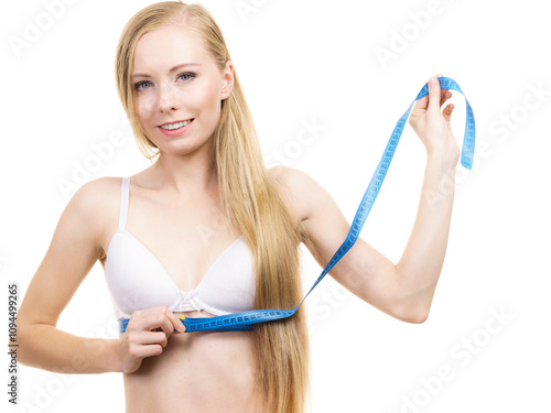 Woman measuring her chest under breast photo