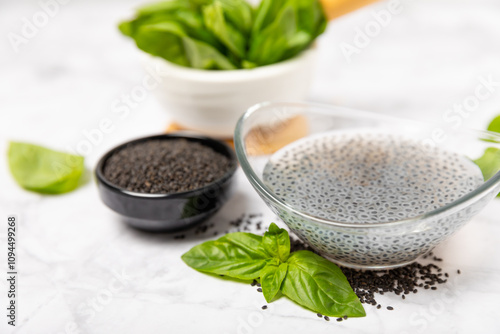 Basil seeds on textured wooden background. Close-up. Superfood. Ocimum basilicum. Organic basil seeds. selasih. Space for text. Copy space. photo