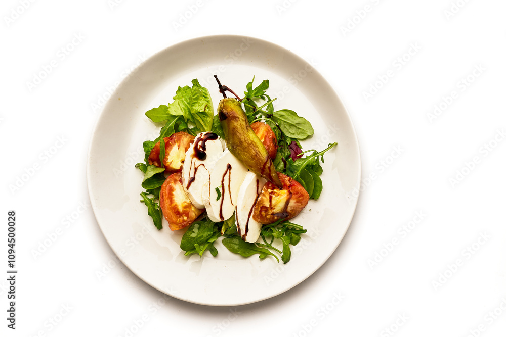 A white plate with a salad of tomatoes, cucumbers, and basil A white plate with a salad of tomatoes, cucumbers, and basil