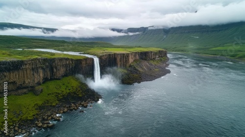 Majestic waterfall flowing into serene river iceland aerial view nature