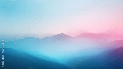 Pastel colored mountain range with fog creating a dreamy atmosphere during sunset