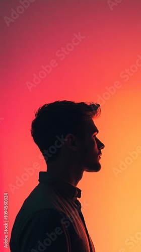 Young man silhouette posing on gradient red and orange background