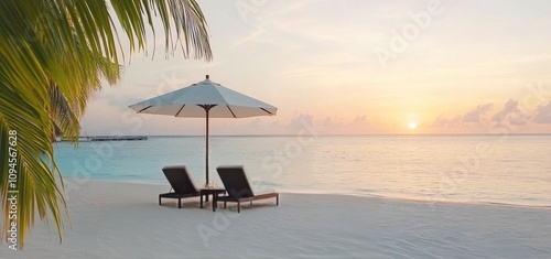 Relaxing evening at a serene beach with lounge chairs and an umbrella near th...