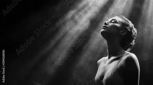 Elegant woman in soft light portrait expressing serenity and beauty in black and white