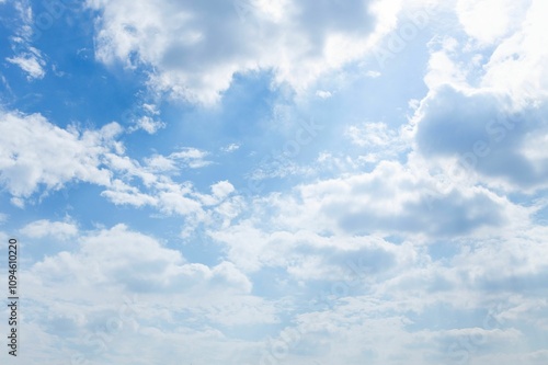 Serene sky with white clouds and sunlight