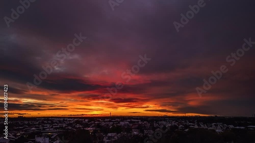 Timelapse of sunrise over snow covered suburban area